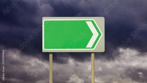 A blank directional road sign with a background of time lapse gathering dark storm clouds. Going no where. Going to an empty future. Going to a stormy and unsettled future.