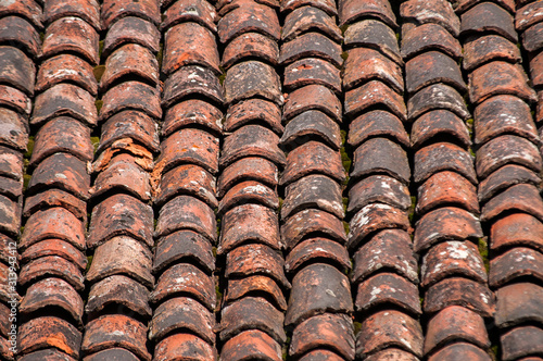 Old vintage red ceramic roof tiles closeup as background © varbenov