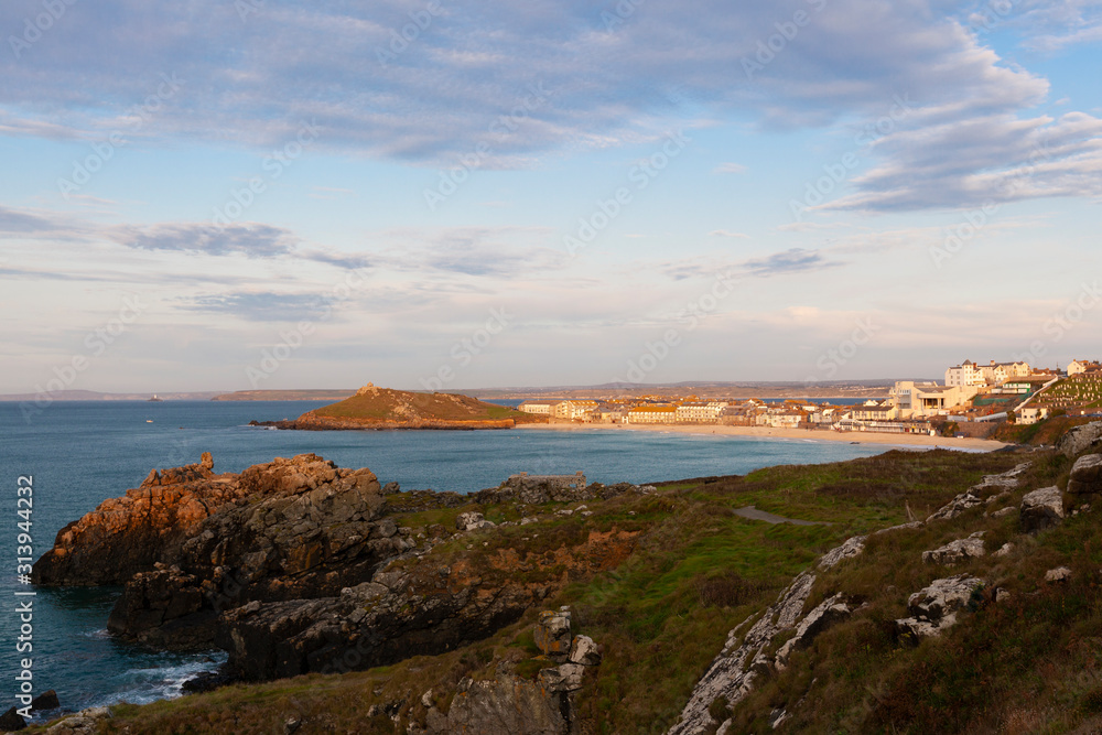 Coastal landscape around Porthmeor Beach at St Ives in Cornwall at sunset Coastal landscape around Porthmeor Beach at St Ives in Cornwall at sunset