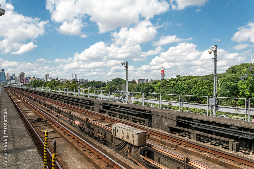 Urban train rail in Sao Paulo, Brazil, with buildings at the backside. Urban train rail, with buildings at the backside. Urban train rail in Sao Paulo, Brazil, with buildings at the backside. Urban train rail, with buildings at the backside.