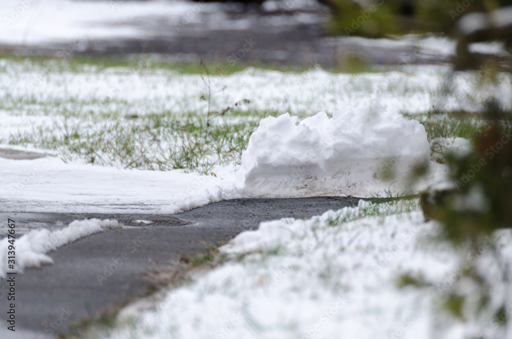 Pile of snow after winter service on a path Pile of snow after winter service on a path