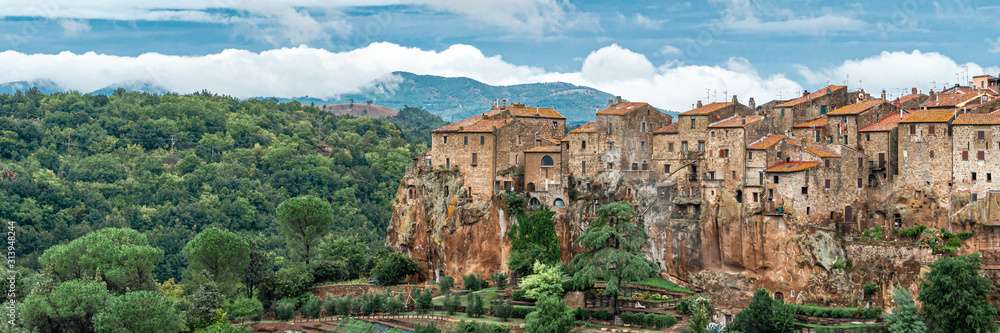 View of the medieval village Pitigliano founded in Etruscan time on the tuff hill, Tuscany, Italy. Panoramic wide banner
