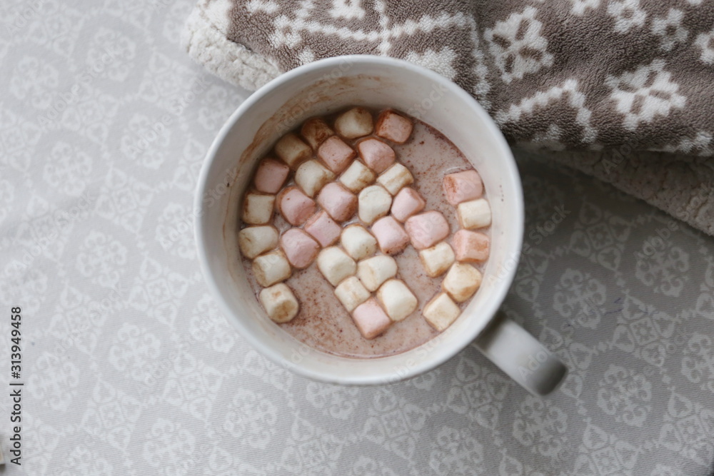 cocoa with marshmallows in a large white cup on the table cocoa with marshmallows in a large white cup on the table