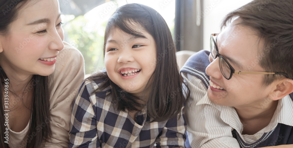 Portrait of happy asian family spending time together in living room. family and home concept Portrait of happy asian family spending time together in living room. family and home concept