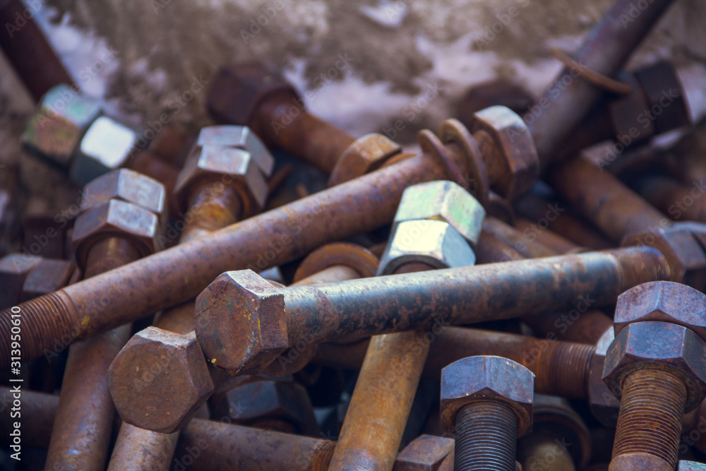 Industrial look. Bolts and nuts for fastening metal parts Industrial look. Bolts and nuts for fastening metal parts