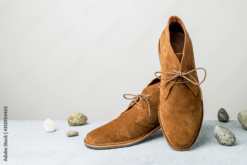 Fashion - men's camel suede desert shoes (boots) on grey - obrazy, fototapety, plakaty 