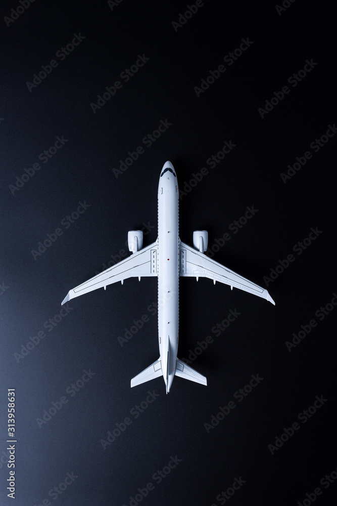 Travel concept. Top view of Jet airliner on black background. Commercial passenger or cargo aircraft, business jet ready for flight Travel concept. Top view of Jet airliner on black background. Commercial passenger or cargo aircraft, business jet ready for flight