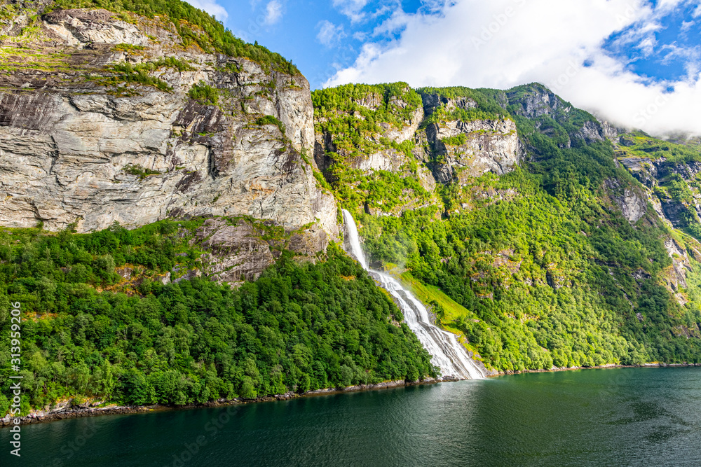 View on Friarfossen waterfall in Geiranger fjord from cruise ship in summer