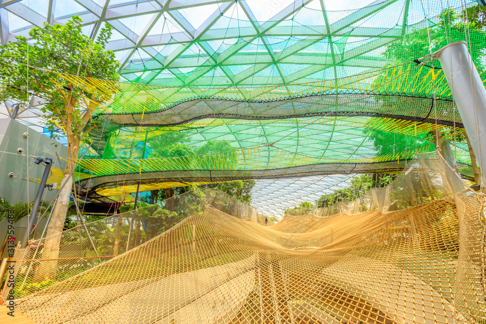 Singapore - Aug 8, 2019: Manulife Sky Nets Bouncing the most fun attraction  in Canopy Park in Jewel Changi Airport, a nature-themed with gardens,  attractions, retail and restaurants, opened in 2019. Stock