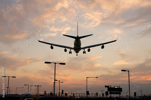 Airplane approaching Heathrow at sunset