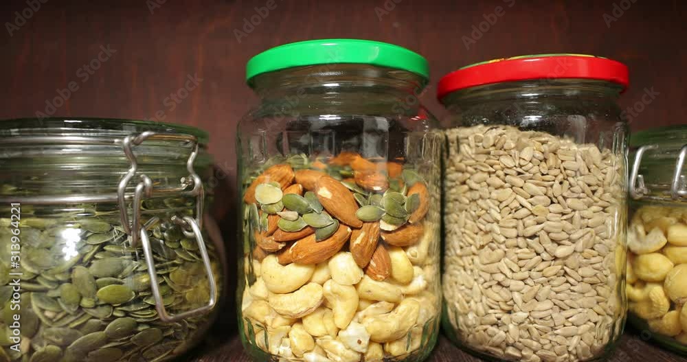 Jars of nuts, seeds, olives, pesto and more things in the pantry, 60 fps 4k footage Jars of nuts, seeds, olives, pesto and more things in the pantry, 60 fps 4k footage