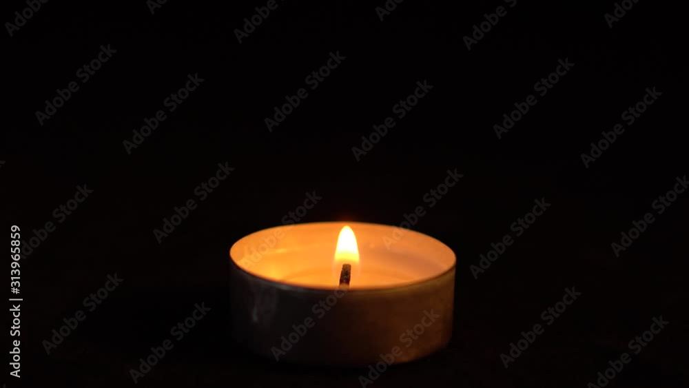Slow motion white candles light up flames fire on isolated black background. Use in romantic dinner, warm and relax peace maditaion, use for spiritual religion church decotion and Halloween graveyard Slow motion white candles light up flames fire on isolated black background. Use in romantic dinner, warm and relax peace maditaion, use for spiritual religion church decotion and Halloween graveyard