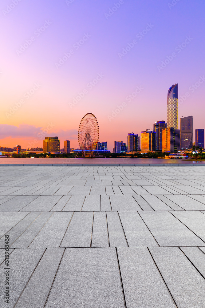 Empty square floor and modern city skyline with buildings in suzhou at night,China.