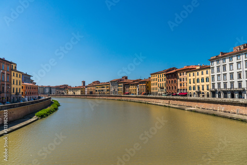 Traditional colorful ancient Italian architecture houses in Pisa, Italy, alongside the embankment of Arno river © Aleksandr Vorobev