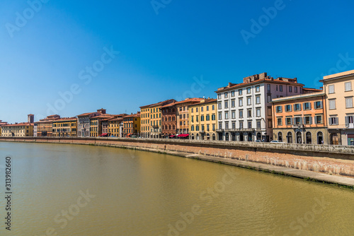 Traditional colorful ancient Italian architecture houses in Pisa  Italy  alongside the embankment of Arno river
