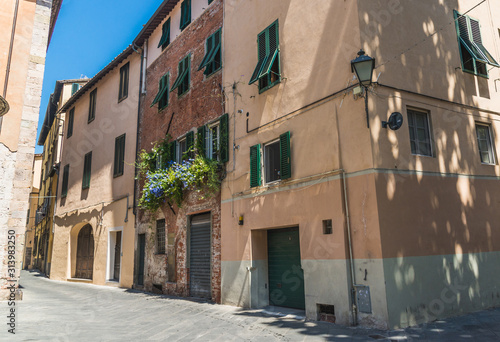 Narrow streets of Lucca ancient town with traditional architecture, Italy