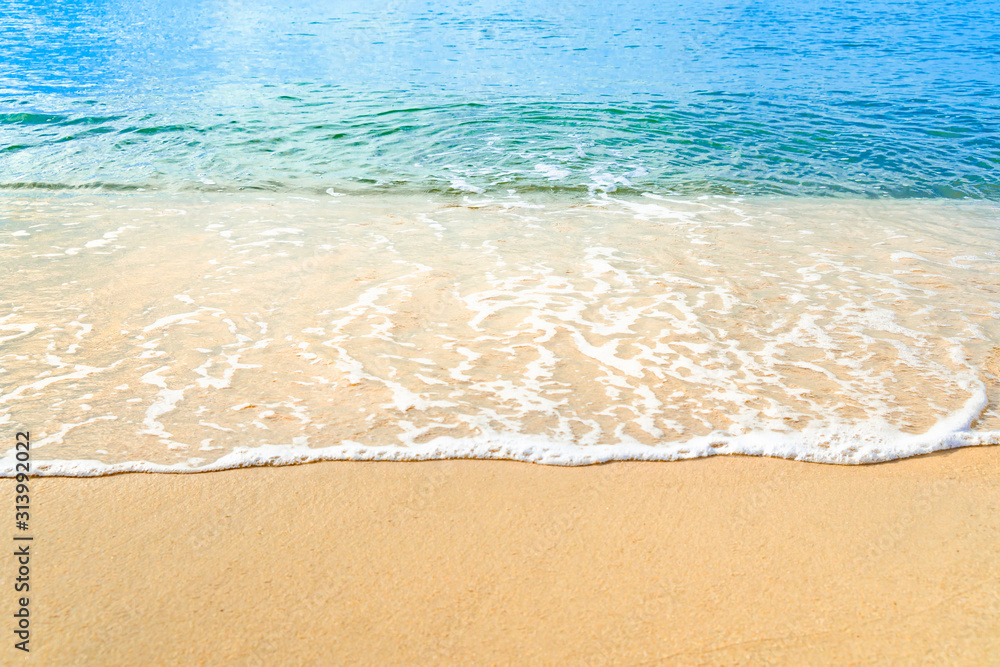 Ocean wave on tropical beach with golden sand and ripple of water splash from emerald blue-green sea water during summer vacation. Ocean wave on tropical beach with golden sand and ripple of water splash from emerald blue-green sea water during summer vacation.