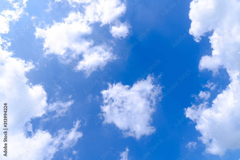 Fototapeta premium The blue summer sky with white fluffy clouds. Photo from window on the airplane.