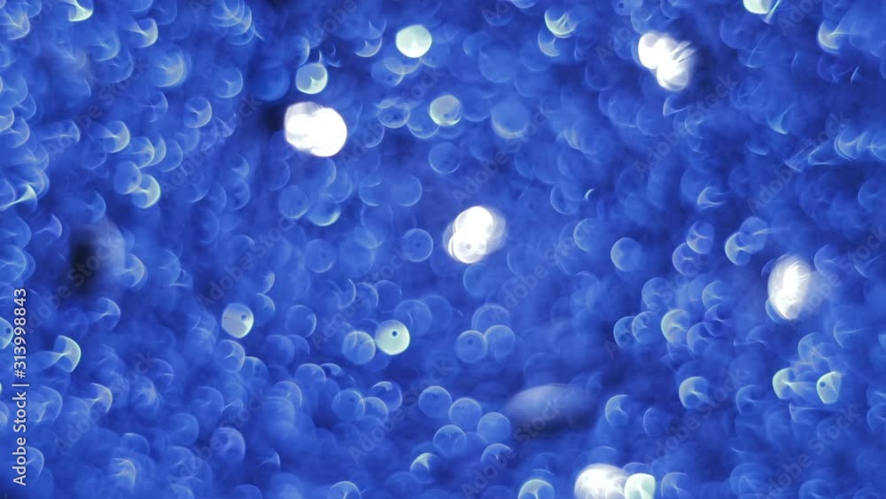 Blinking, glittering and sparkling blue bokeh lights inside the New Year or Christmas light ball in night illumination Blinking, glittering and sparkling blue bokeh lights inside the New Year or Christmas light ball in night illumination