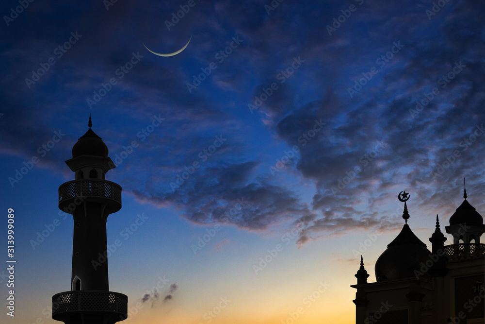 silhouette of mosque at sunset and crescent moon