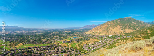Landscape view of Salt Lake City Utah suburbs against mountain and blue sky