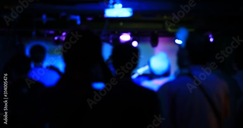 The audiences at the rock club handheld defocused photo