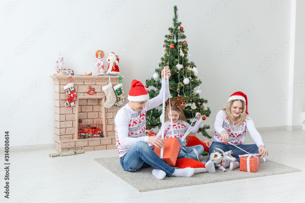 Holidays and presents concept - Portrait of a happy family opening gifts at Christmas time