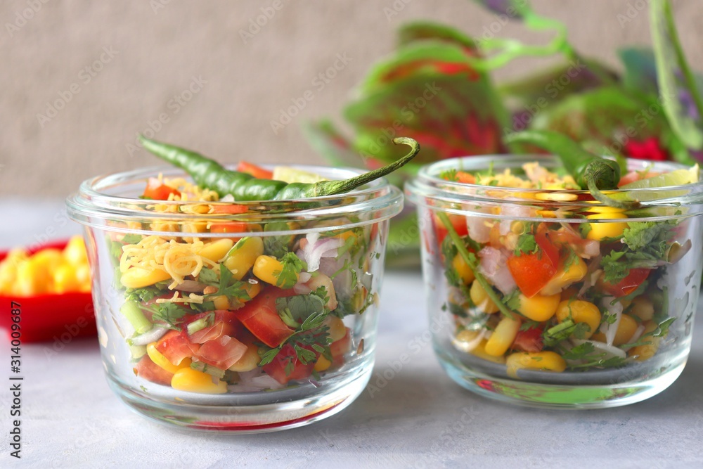 Food vegetable salad with corn and onions, tomatoes, coriander, lemons. healthy green meal. Indian Corn Masala chaat. Recipe ingredients with copy space, Food vegetable salad with corn and onions, tomatoes, coriander, lemons. healthy green meal. Indian Corn Masala chaat. Recipe ingredients with copy space,