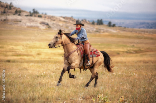 Cowgirl on Buckskin photo