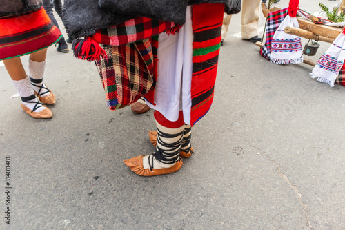 Sighetu Marmatiei, Romania: Maramures traditional costumes. Traditional Romanian peasant sandals which is worn with the Romanian peasant costume at Winter Customs and Traditions Marmatia Festival