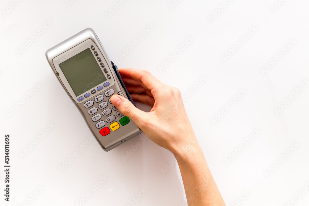 Payments security. Hand enters pin - password - on white background top-down copy space Payments security. Hand enters pin - password - on white background top-down copy space