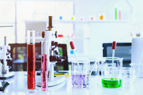 test tubes with lab glassware on the table in laboratory background, research and Scientific concept