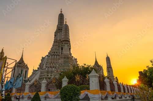 Large illuminated temple Wat Arun after sunset seen accross river Chao Phraya Bangkok  Thailand.golden Buddha in side temple Wat Arun the biggest and tallest pagoda in the world