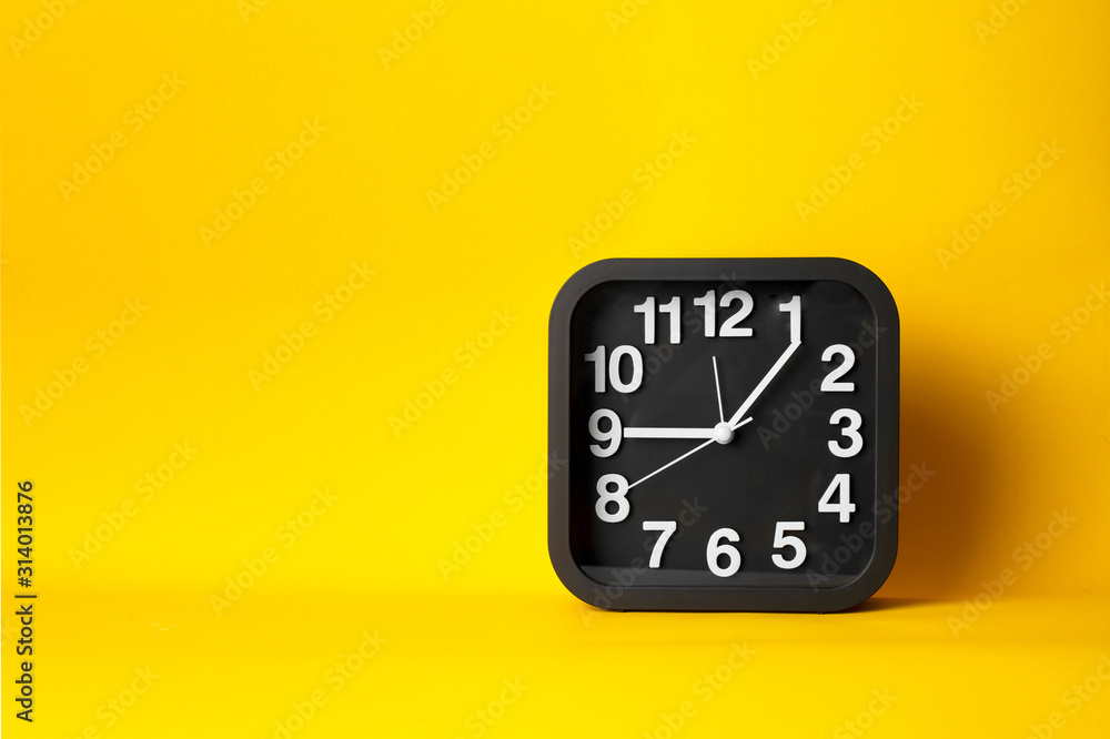 black and white clock time face on yellow background black and white clock time face on yellow background