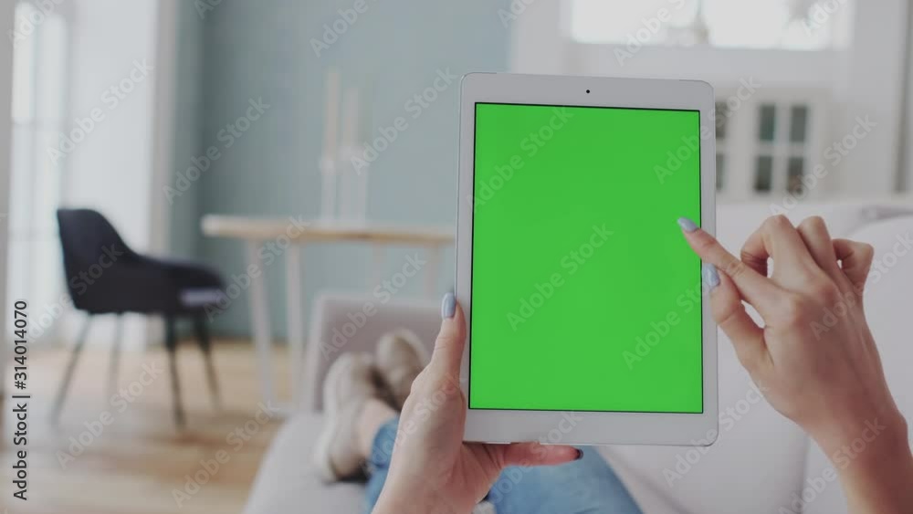 Tablet PC with Chromakey Green Screen at Home. Mock-Up Tracking Touchpad. Double Click, Swipes, Zoom In, Zoom Out, Slide, Browse News, Surfing Social Media. Entertainment by modern gadget at Home. Tablet PC with Chromakey Green Screen at Home. Mock-Up Tracking Touchpad. Double Click, Swipes, Zoom In, Zoom Out, Slide, Browse News, Surfing Social Media. Entertainment by modern gadget at Home.
