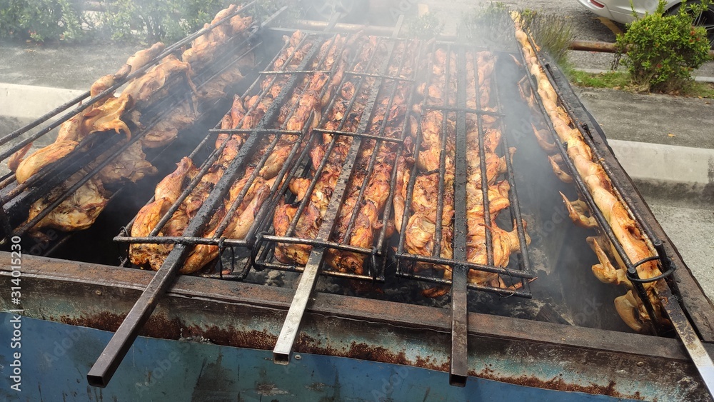 meat on grill.chicken grill is a favorite food of the asian people. it is grilled using charcoal. meat on grill.chicken grill is a favorite food of the asian people. it is grilled using charcoal.
