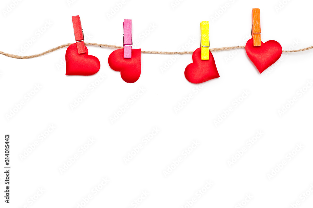Valentine's Day on February 14th. Lot of red hearts on a clothespin on a rope. White background. Valentine concept. Isolated. Wallpaper, flyers, invitations, posters, brochures, banners. Valentine's Day on February 14th. Lot of red hearts on a clothespin on a rope. White background. Valentine concept. Isolated. Wallpaper, flyers, invitations, posters, brochures, banners.