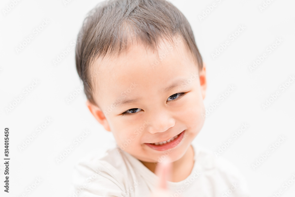 Happy Little asian boy child showing front teeth with big smile and laughing: Healthy happy funny smiling face young adorable lovely toddler kid.Joyful portrait of asian kindergarten school student. Happy Little asian boy child showing front teeth with big smile and laughing: Healthy happy funny smiling face young adorable lovely toddler kid.Joyful portrait of asian kindergarten school student.