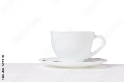 White Cup and saucer on a white table isolated on a white background.