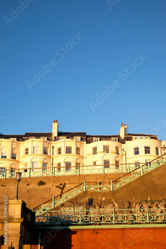 A Typical Brighton Georgian houses on the seafront a staircase in a big brick wall leading to the beach, Brighton, Sussex, UK. a big blue sky, ideal copy space
