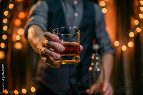 Barman pouring whiskey whiskey glass.