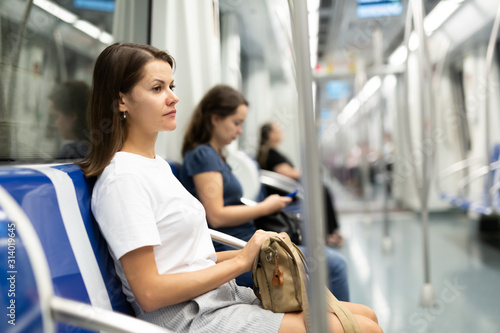 Nice women with handbag in subway car