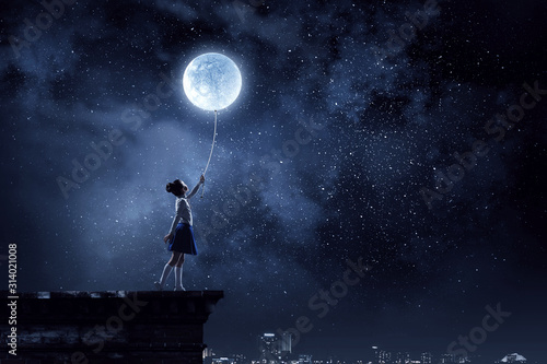 Kid girl catching moon. Mixed media photo