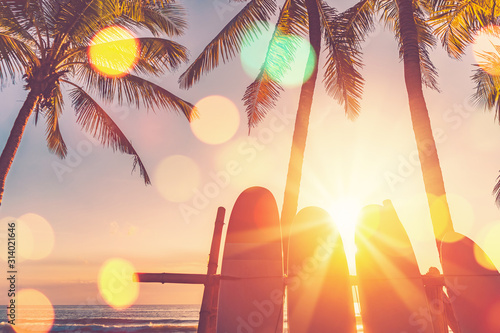 Fototapeta Naklejka Na Ścianę i Meble -  Surfboard and palm tree on beach background.