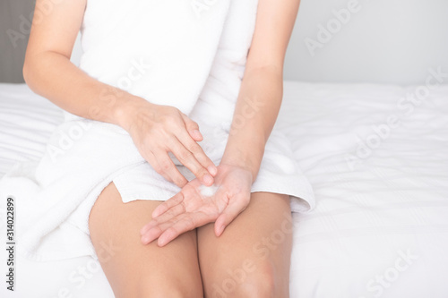 Woman applying moisturizing cream/lotion on hands, beauty concept..