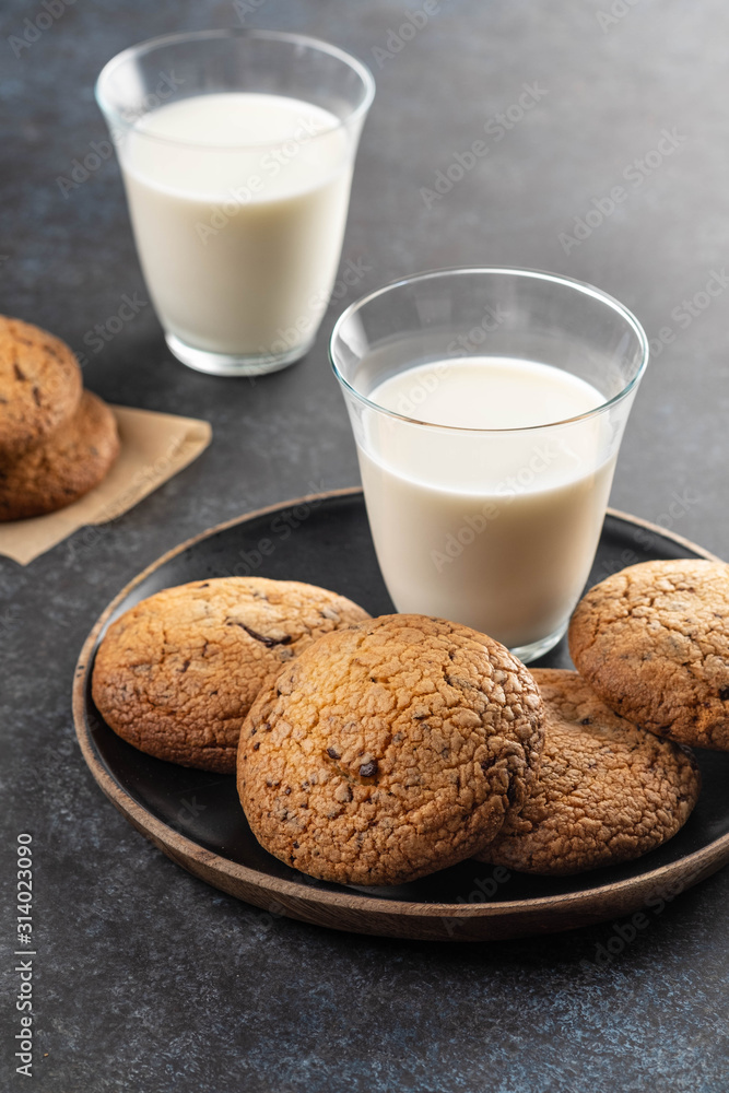 Chocolate chip cookies with milk on black table. Copy space. Chocolate chip cookies with milk on black table. Copy space.