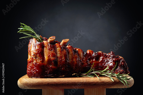 Fotografie, Obraz Grilled pork ribs with rosemary on a wooden board.