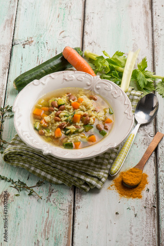 rice soup with mixed vegetables and turmeric photo