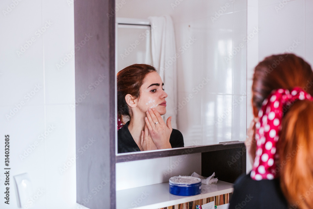 young woman with beauty face in the mirror young woman with beauty face in the mirror