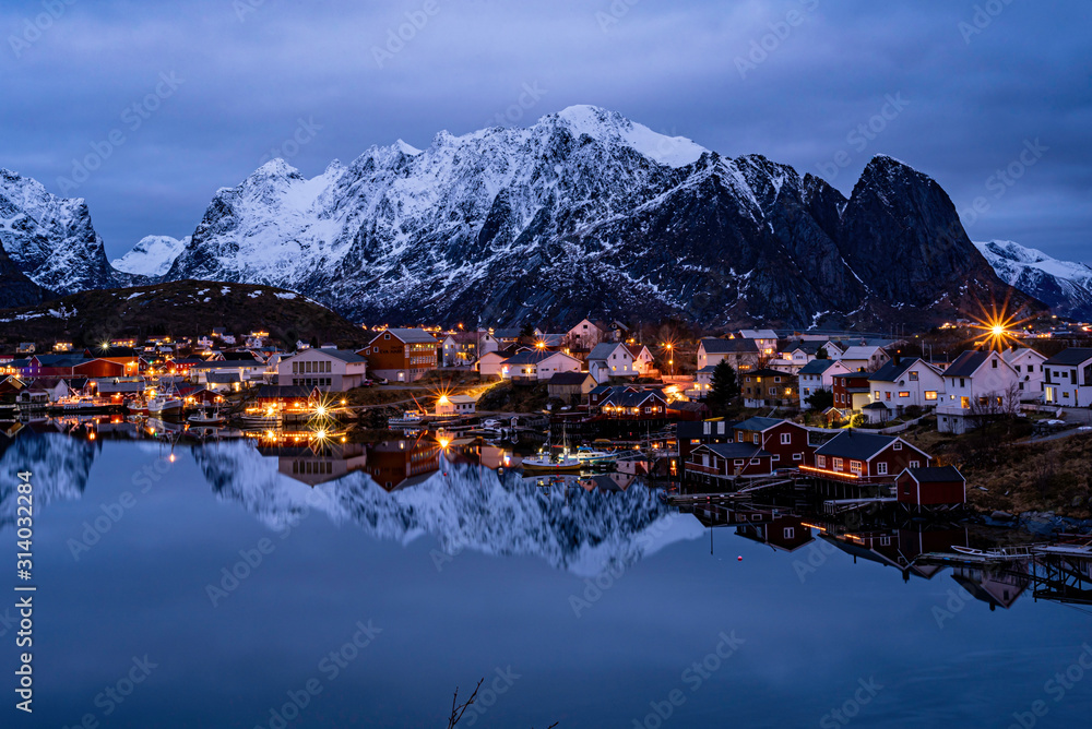 village reflection on water  in the northern sea cold winter frame, night view, blue hour